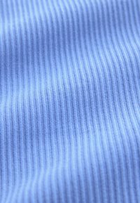 Light blue ribbed fabric with vertical textured lines, soft texture, fine weave, creating a subtle sheen and depth in appearance.