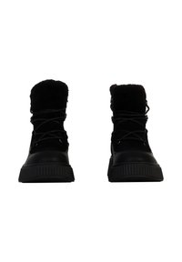 Black ankle boots featuring a textured leather lower and a faux fur collar. Designed with laces and a ridged rubber sole.