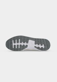 Μαύρη και λευκή σόλα παπουτσιού Nike με υφή στην επιφάνεια και το λογότυπο της Nike στο κέντρο, απομονωμένη σε λευκό φόντο.