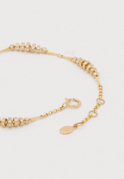 Colier cu ton auriu, având segmente alternative netede și texturate, împodobit cu mici cristale clare; dispune de închizătoare lobster și lanț de prelungire.