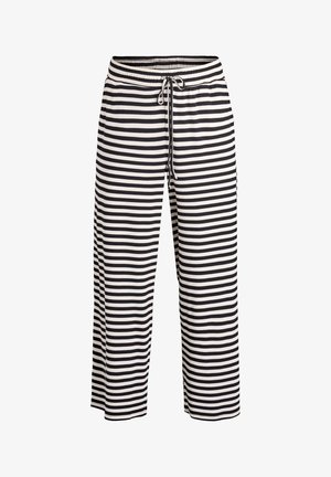 Črno-bele široke hlače s črtami, z elastičnim pasom in vrvico za zatezanje. Narejene iz rebrastega tkanine, s sproščenim krojem.