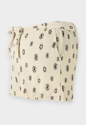 Svijetlosmeđi šorts s crnim geometrijskim uzorcima, s remenom na struku, bočnim džepovima i opuštenim krojem. Izrađeni od mekog materijala.