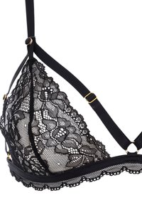Bralette en dentelle noire avec des bonnets transparents, des motifs floraux et des bretelles en satin ajustables. Comprend des accessoires en métal doré et une finition en dentelle à bords festonnés.