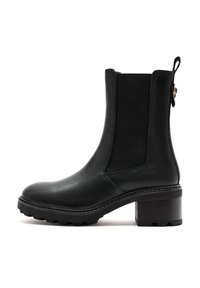 Black leather ankle boot with elastic side panels, rounded toe, and a textured block heel. Detailed stitching and a pull tab at the back.