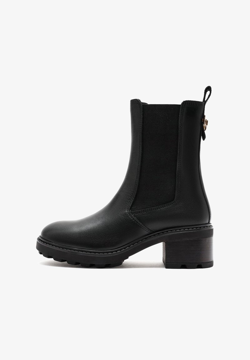 Black leather ankle boot with elastic side panels, rounded toe, and a textured block heel. Detailed stitching and a pull tab at the back.