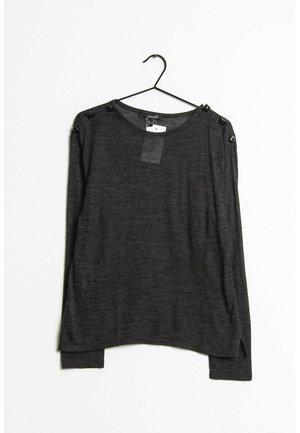 Dark gray long-sleeve top made from soft fabric. Features a loose fit, rounded neckline, and decorative buttons on the shoulders.