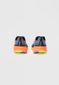 Men's running shoes featuring a grey mesh upper, orange midsole, and neon green outsole. Back view shows prominent logo and design accents.