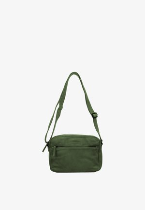 Small green leather crossbody bag with front zip pocket and adjustable shoulder strap on a white background.
