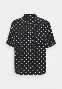 Short-sleeve black shirt with white polka dots, button front, and single chest pocket. Made of lightweight fabric with a smooth texture.
