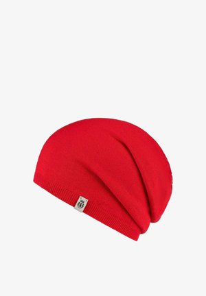 Red knitted beanie hat with a soft texture, slouchy design, and a folded hem. Features a small brand label on one side.