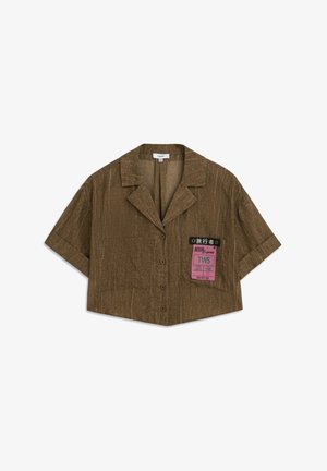 Korte mouwen, verkort shirt in gestructureerde bruine stof met een knoopsluiting en een notch-kraag. Heeft een bedrukte label aan de linkerzijde.