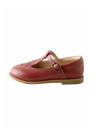 Red leather Mary Jane shoe with a cut-out design on the toe, adjustable strap with a buckle, and a light brown rubber sole.