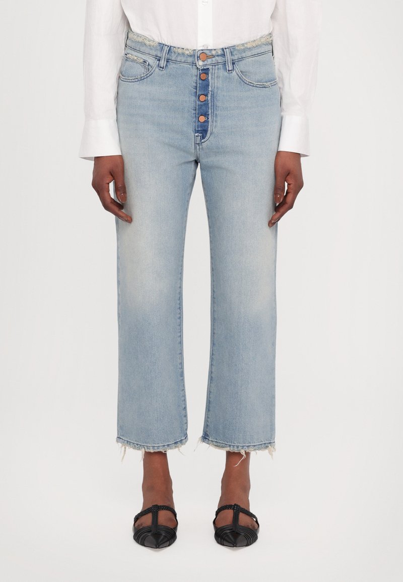 Jeans in denim blu chiaro con vita alta, chiusura con cinque bottoni e orlo grezzo. Abbinati a scarpe nere basse.