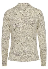 Veste beige à manches longues avec un petit motif abstrait à pois marron foncé, col pointu et taille cintrée, vue de dos.