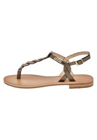 Brown leather sandal with a braided toe strap, adjustable ankle strap, flat sole, and minimalistic design.