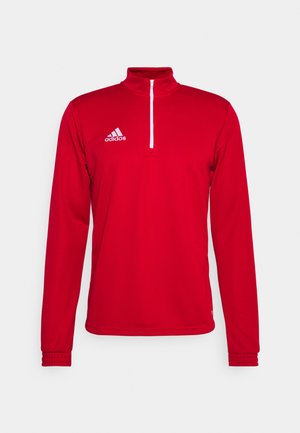 Rode sportieve pullover met een hoge kraag, een halve rits aan de voorkant, lange mouwen en elastische manchetten. Bevat een wit Adidas-logo op de linkerborst.