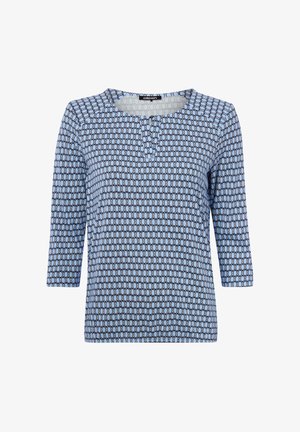 Hellblaues Langarmhemd mit schwarzem Ovalmuster, rundem Ausschnitt und drei Knöpfen in der vorderen Mitte.