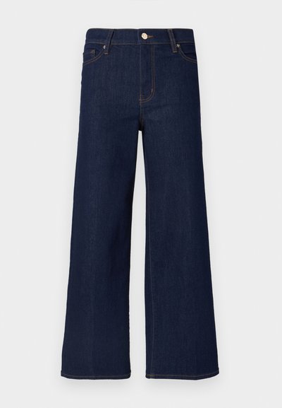 Tumedast teksast laiade säärega püksid kõrge vöökohaga, esitaskute ja nähtavate õmbluselementidega, klassikalise nööpkinnitusega.