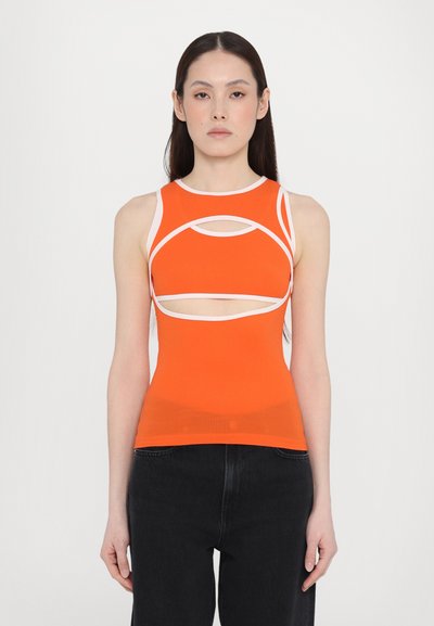 Orange sleeveless top with white accents and cut-out details, featuring a fitted design and soft, stretchy material.