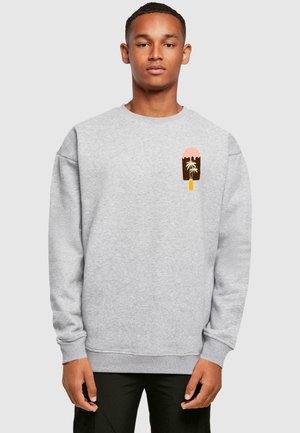 Grauem Sweatshirt mit Rippbündchen und -saum, das ein Fronttaschendesign mit einem grafischen Motiv von einem pinken und braunen Eis am Stiel sowie einer Palme aufweist.