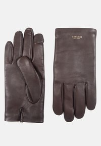 Bruna läderhandskar med en slät yta, design med fem fingrar och en liten accentlogotyp vid handleden. Har en åtsittande form för värme.