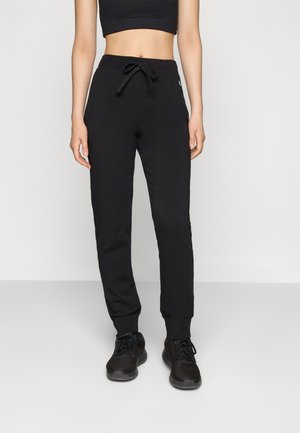 Svarte joggebukser med snøring i livet, smalere ben og elastiske mansjetter. Laget av mykt stoff, designet for komfort og bevegelsesfrihet.