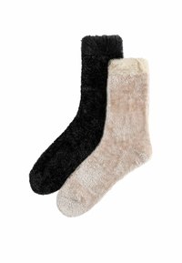 Black and beige plush socks with a soft, fluffy texture. The black sock features a darker cuff, while the beige sock has a light cream cuff.