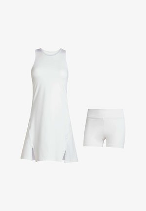 White athletic dress with sleeveless design and side slits, paired with white fitted shorts. Made of smooth, lightweight fabric.