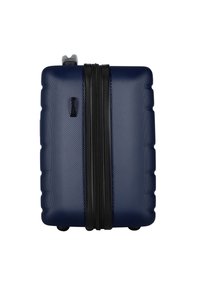 Valigia rigida di colore blu navy, con superficie testurizzata, zip nera e forma rettangolare compatta. Inclusa una maniglia superiore liscia.