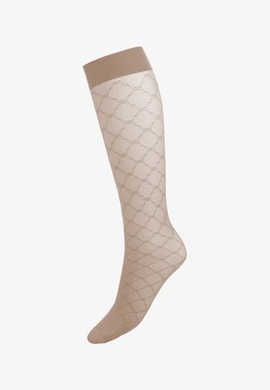 Chaussette de compression beige jusqu'au genou avec texture en losange et bord élastique solide en haut.