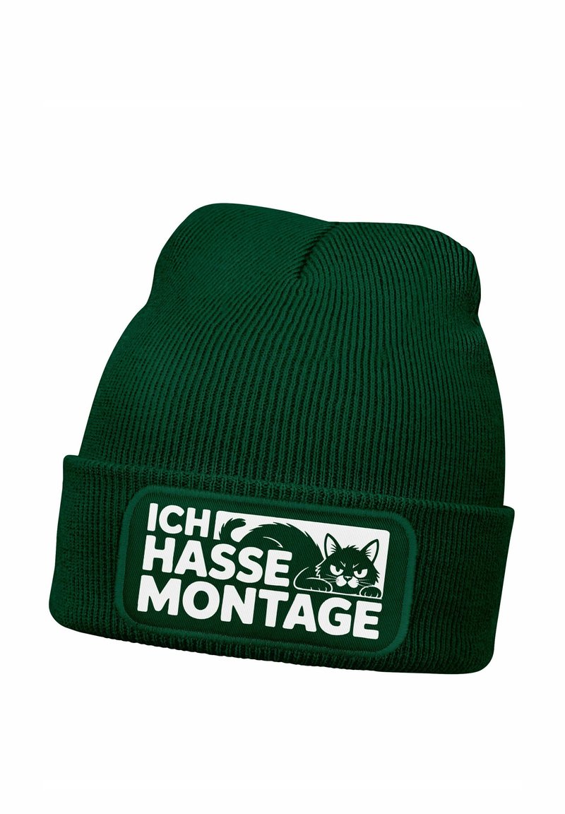 Green knit beanie with a ribbed texture, featuring a rectangular patch displaying the text "ICH HASSE MONTAGE" and a cat graphic.