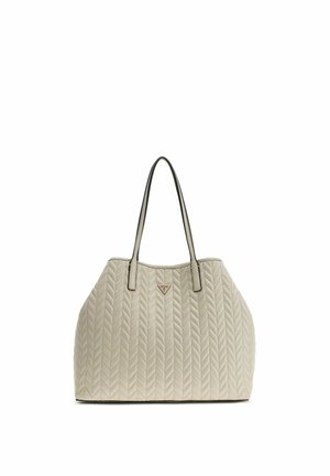 Sac à main en cuir matelassé beige avec motif chevrons, double anses fines et petit logo triangulaire au centre avant.