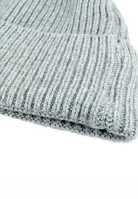 Light gray knitted wool beanie hat with a folded brim, laid flat on a white background.