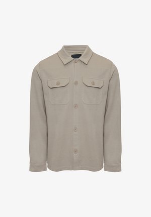 Světlý béžový košilový svetr vyrobený z měkké tkaniny. Obsahuje límec, dvě náprsní kapsy a hnědé knoflíky. Dlouhé rukávy s manžetami.