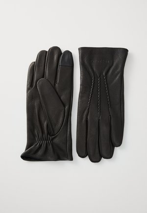 Black leather gloves with a smooth texture, elasticized wrist, and stitch detailing. Features a touchscreen-compatible fingertip on one glove.