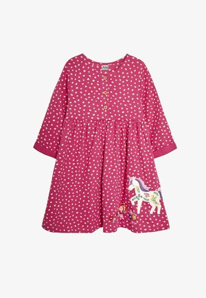 Vestido rosa de manga larga con lunares blancos, detalle de botones en el cuello y un unicornio bordado con acentos florales en la falda.