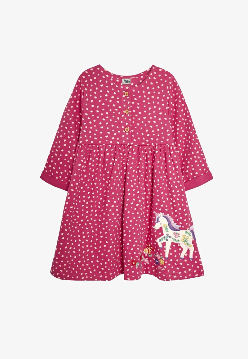 Hosszú ujjú, rózsaszín ruha fehér pöttyökkel, gombos részletekkel a nyakán, és hímzett egyszarvú virágmintákkal a szoknyán.