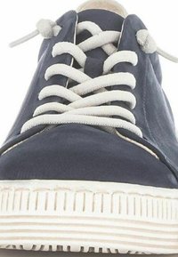 Navy blue canvas sneaker with white laces, rubber sole, and textured side panel. Minimalist design with a round toe and subtle stitching details.