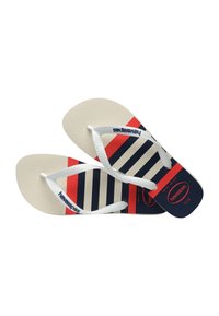 Paire de tongs beige avec des brides blanches, avec des rayures bleu marine et rouges et le logo « havaianas » sur les brides et les semelles.