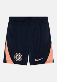 Tumesinised spordilühikesed püksid heleda oranži külgdetailiga, Nike logo ja Chelsea FC embleem; valmistatud hingavast, tekstureeritud kangast.