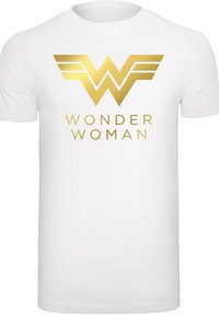 Balta kokvilnas T-krekls ar zelta Wonder Woman logotipu, kurā redzams stilizēts 'W' un uzraksts "WONDER WOMAN" zem tā.