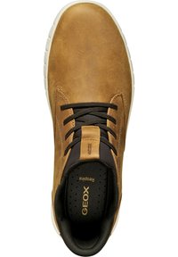 Brown leather shoe with a smooth texture, black laces, and a white rubber sole. Features 'GEOX' branding on the tongue and insole.
