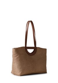 Tan textured tote bag with a brown leather handle and circular cutout. Features a speckled pattern on the body, offering a soft, durable finish.