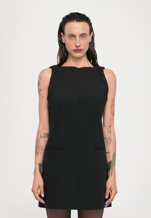 Black sleeveless dress featuring a fitted silhouette, straight neckline, two front pockets, and decorative stitching. Material has a smooth texture.