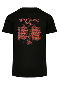 Black cotton t-shirt featuring red and orange "WORLD SACRIFICE TOUR" text and detailed event list with decorative elements on back.