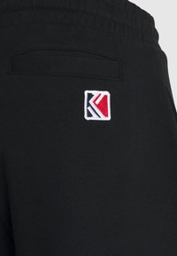 Karl Kani Teplákové kalhoty - black