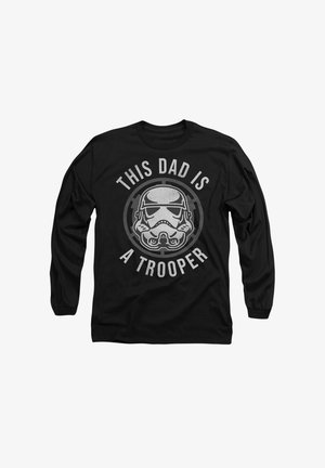 Schwarzes Langarm-T-Shirt mit einem Stormtrooper-Graphic und dem Text "DIESER VATER IST EIN TROOPER" in Silber, kreisförmigem Design um das Bild.