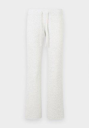 Ljusgrå utsvängda mjukisbyxor av mjukt material. Har resår i midjan med dragsko och en borstad yta. Inga mönster.