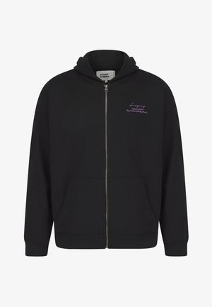 Crna zip-up dukserica od mekog pamuka, s prednjim džepom, rebrastim manžetama i ljubičastim logotipom na lijevoj strani prsiju. Glatka tekstura.