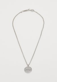 Silver pendant necklace with a round charm featuring a cursive inscription. The chain has a simple, linked design and clasp closure.